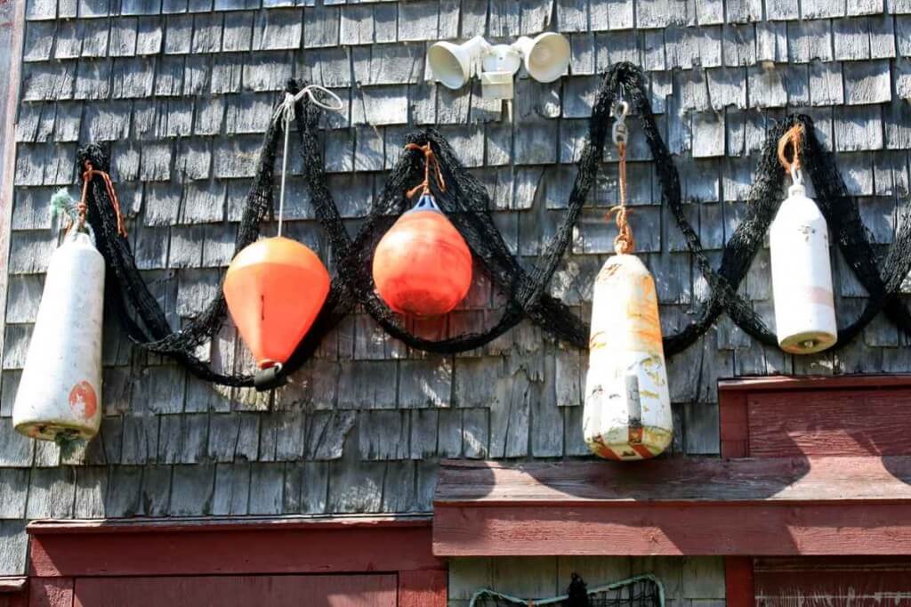 Lobster buoys on the shingle walls in Seal Cove © Copyright Monika Fuchs, TravelWorldOnline