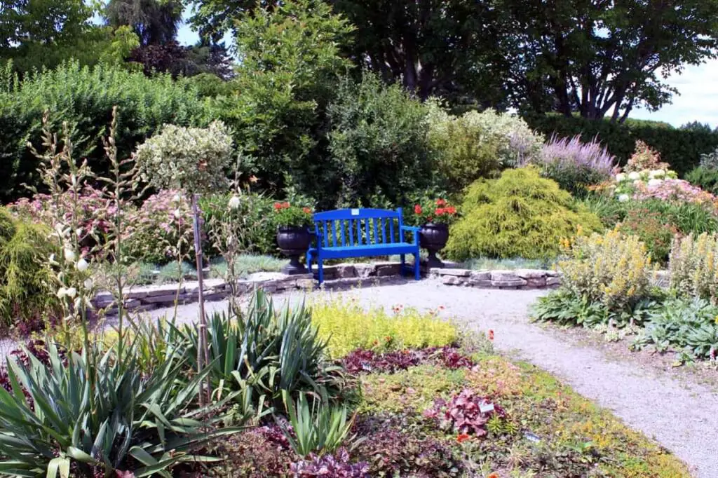 A blue bench between hardy plants © Copyright Monika Fuchs, TravelWorldOnline
