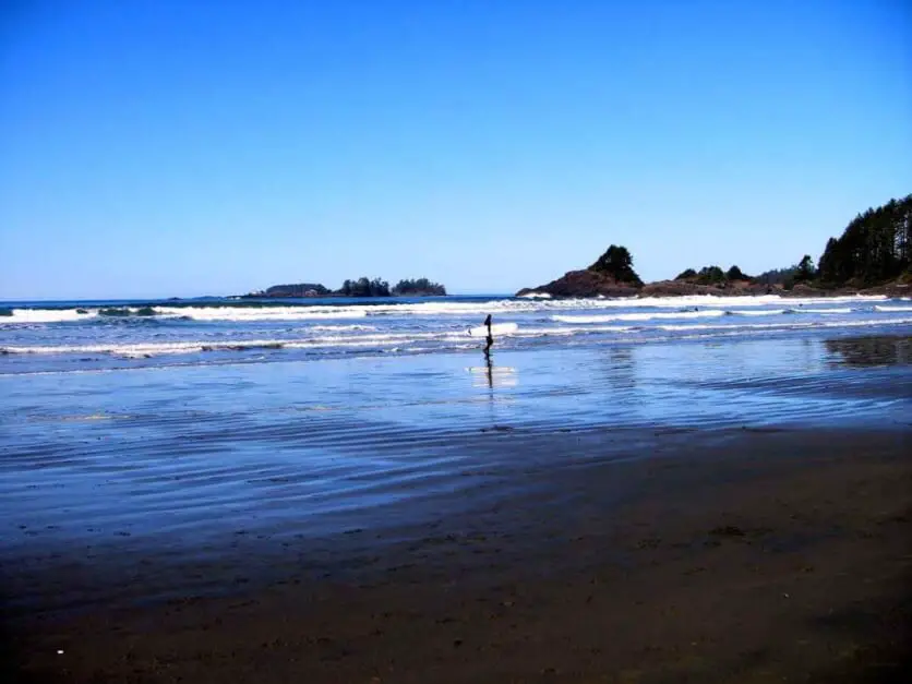 Lone beach hiker on Long Beach on Vancouver Island, on one of the most beautiful beaches in Canada