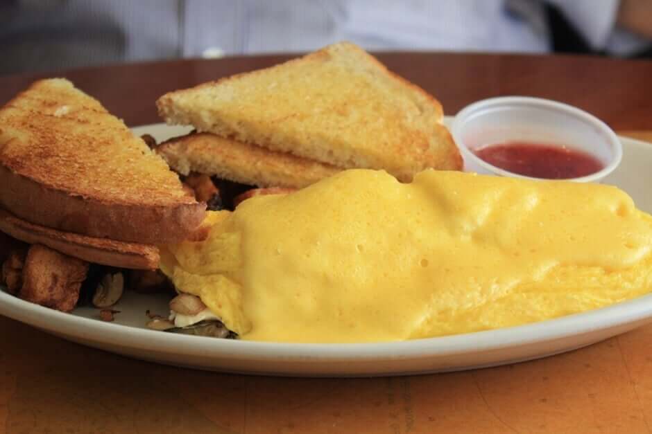 Omelet with Toast and Mushrooms - American breakfast with Eggs Benedict, breakfast omelette and waffles