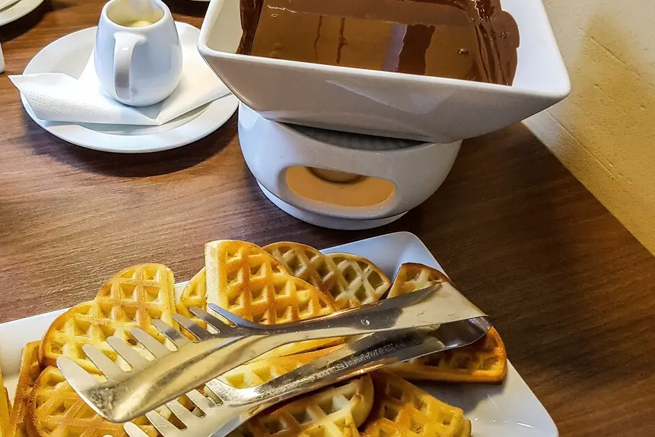 Waffles with Chocolate Sauce - American breakfast with Eggs Benedict, breakfast omelette and waffles