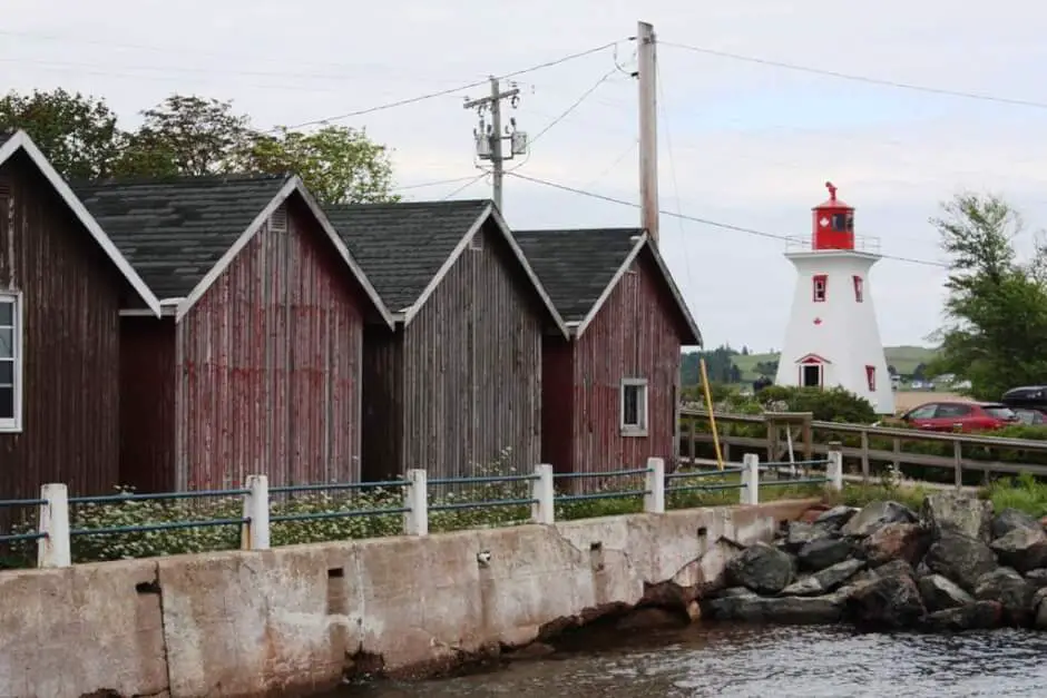Lighthouse and fisherman's cabins in Victoria By the Sea