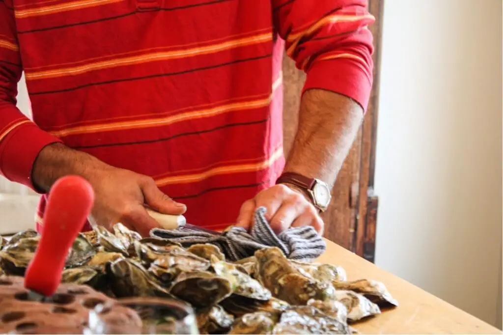 John opens oysters