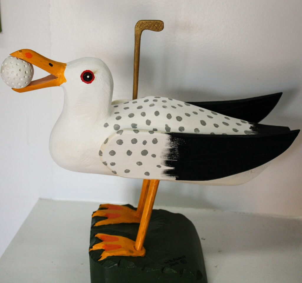 Seagull with golf ball by William Roach