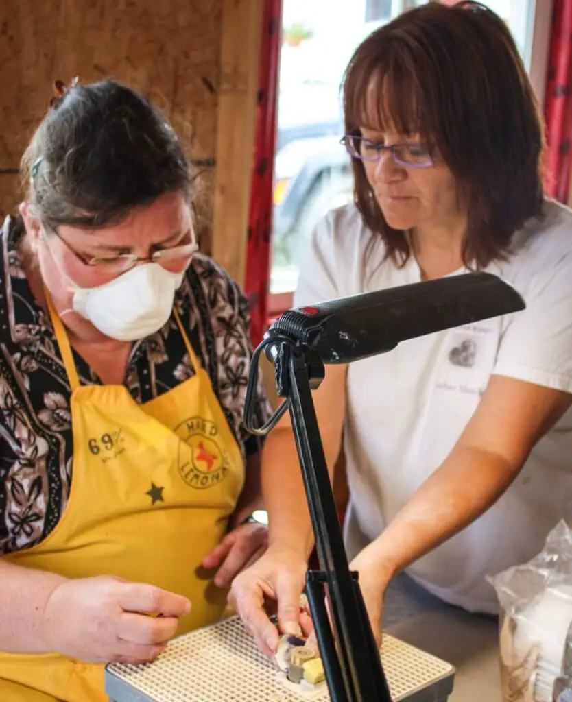 Marcia shows me how to make seashell jewelry