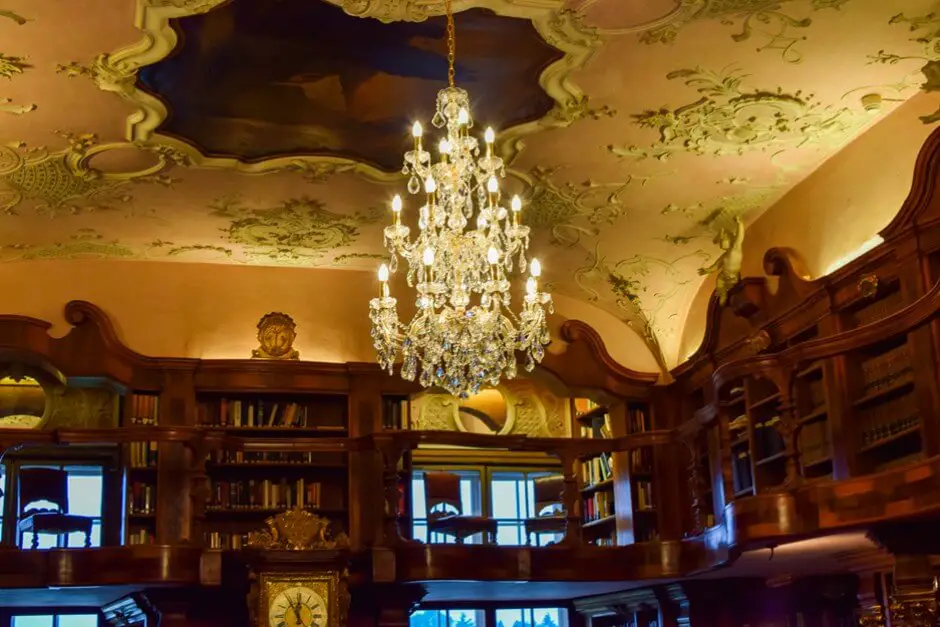 Magnificent chandeliers and ceiling paintings adorn the library in Schloss Leopoldskron