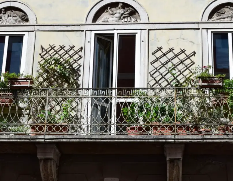 Window front with wrought iron balcony near the Trieste harbor
