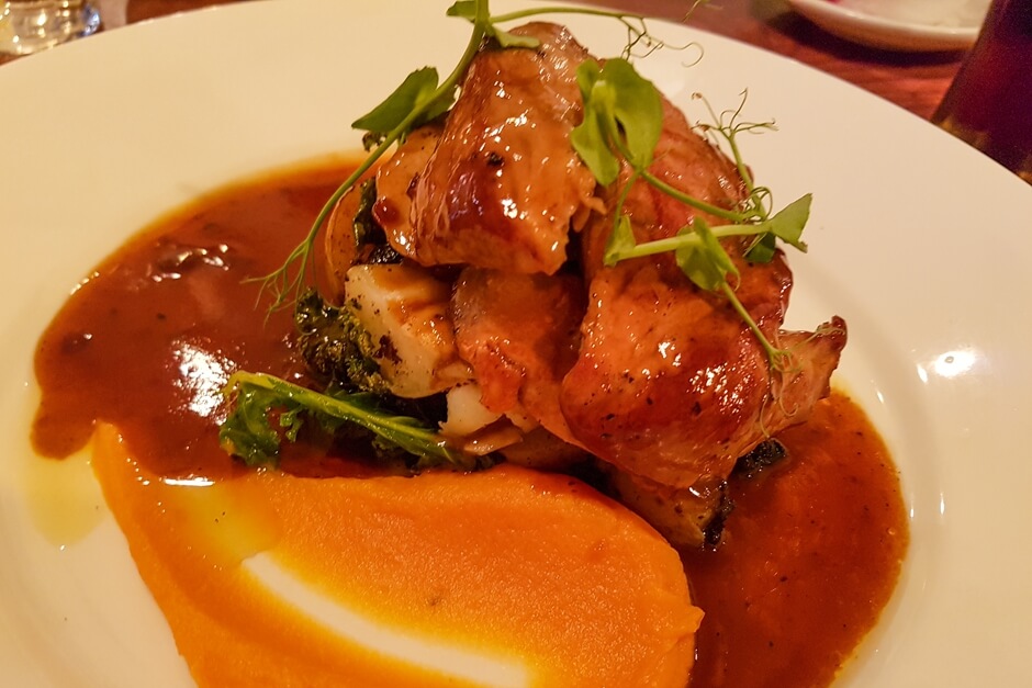 Pork belly on pumpkin puree with red wine sauce