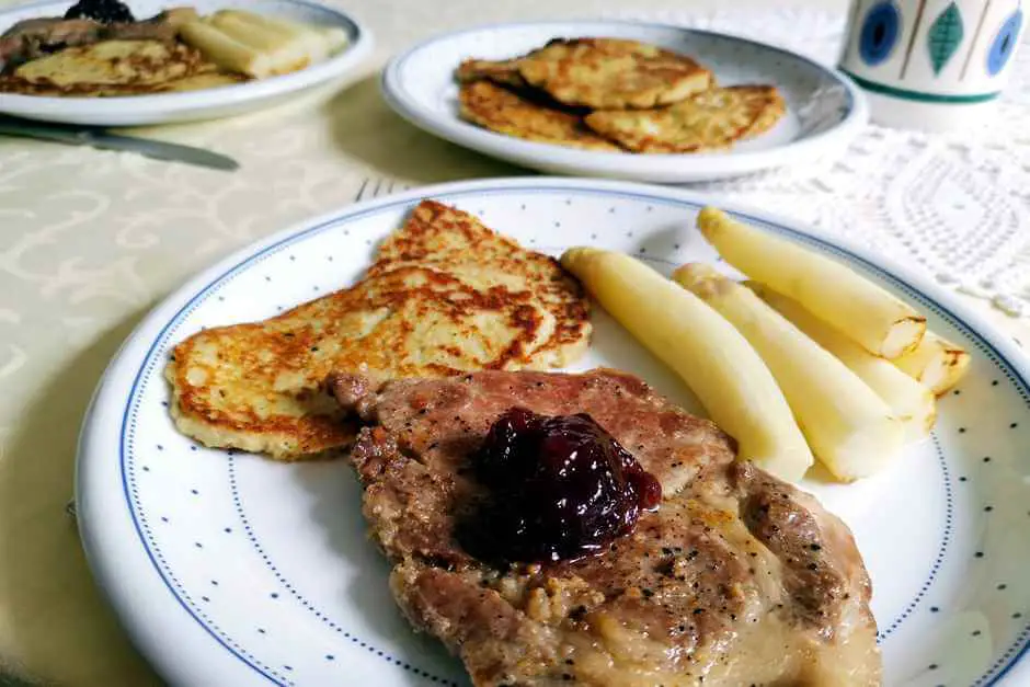 Asparagus spears with pork chops and potato pancakes