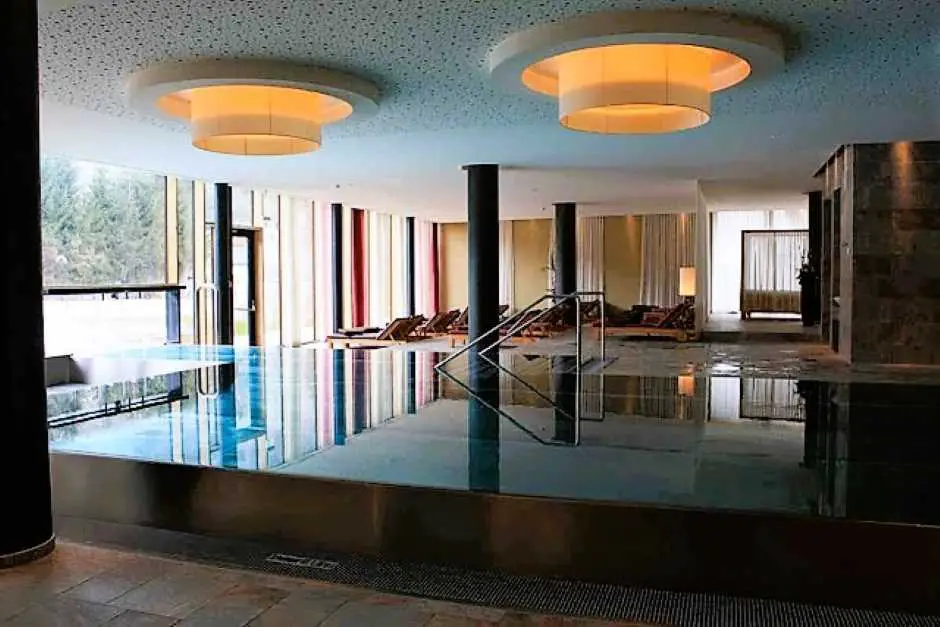 Bright light streams through the large window front into the interior of the pool area