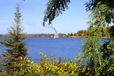 The Seguin on the lake through autumn trees