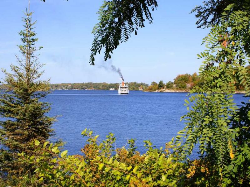 The Seguin on the lake through autumn trees