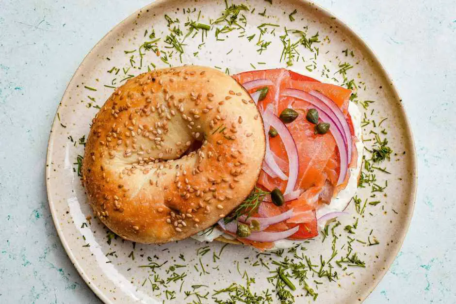 Bagel with salmon goes well with American breakfast with eggs Benedict, breakfast omelet and waffles