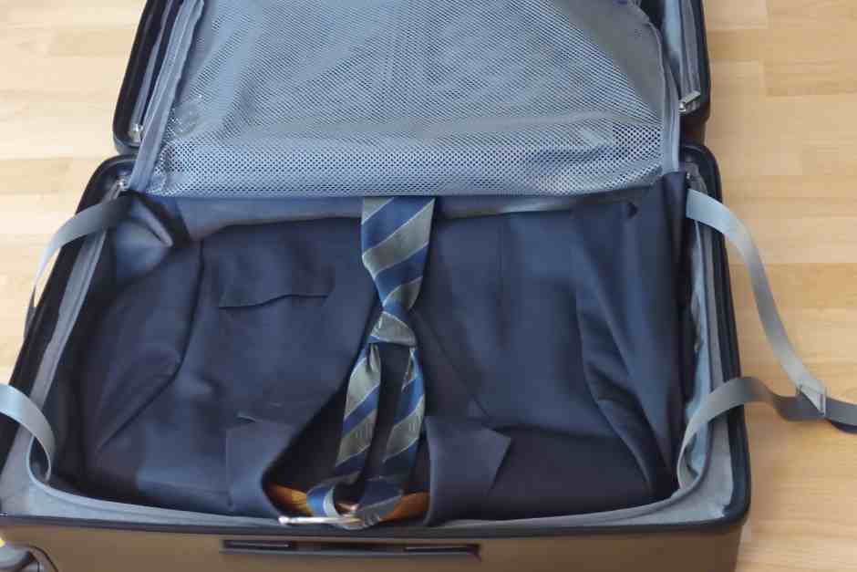 A suit fits perfectly in the suitcase